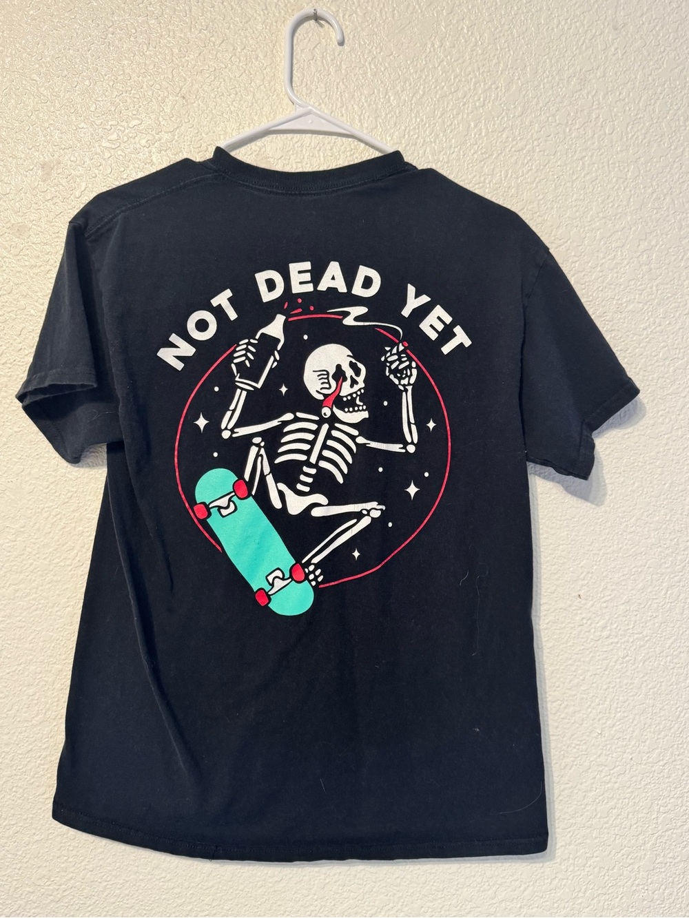 Spencer's Black Tee with Skeleton Skate Graphic and Teal Skateboard